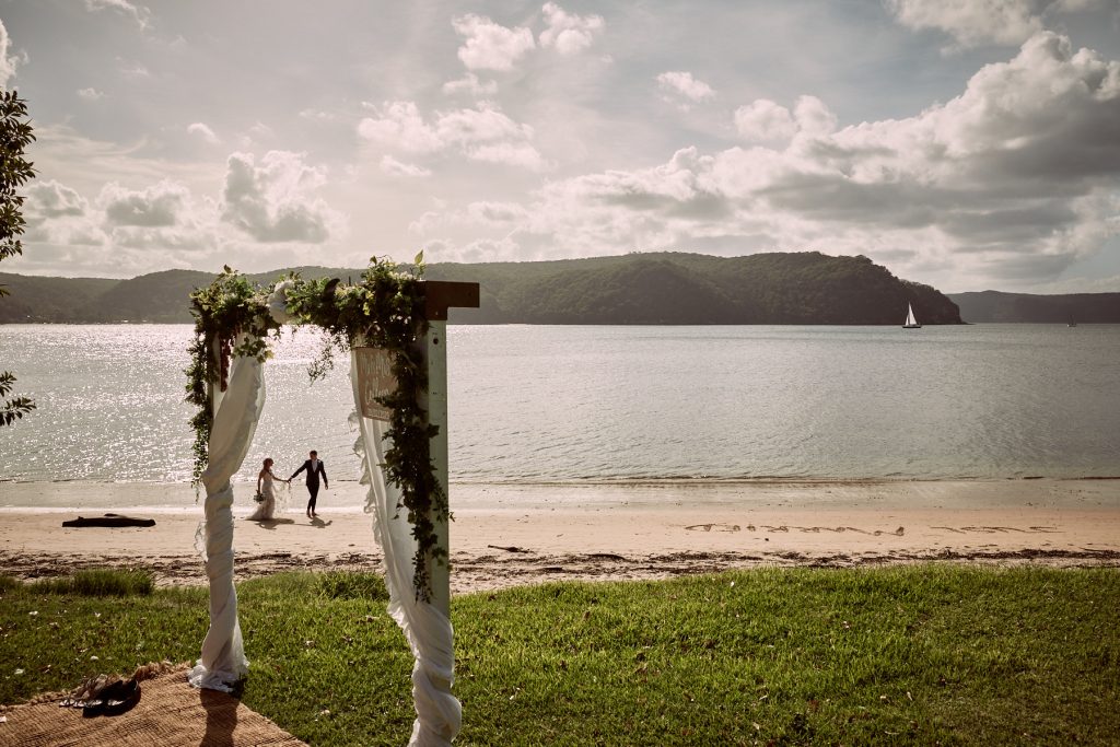 Bride and groom walking along the beach at their Palm Beach wedding
