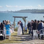 Bride and groom kissing at Q Station Manly waterfront wedding ceremony