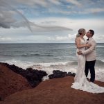 Emma and Josh kissing by the ocean during their Long Reef Golf Club wedding