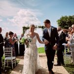 Emma and Luke walking down the aisle after their wedding ceremony at Palm Beach Golf Club